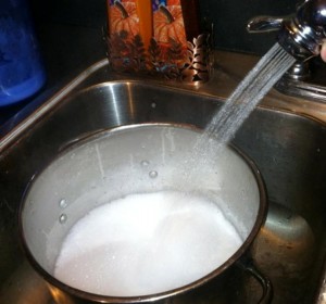 Slowly add baking soda and hot water